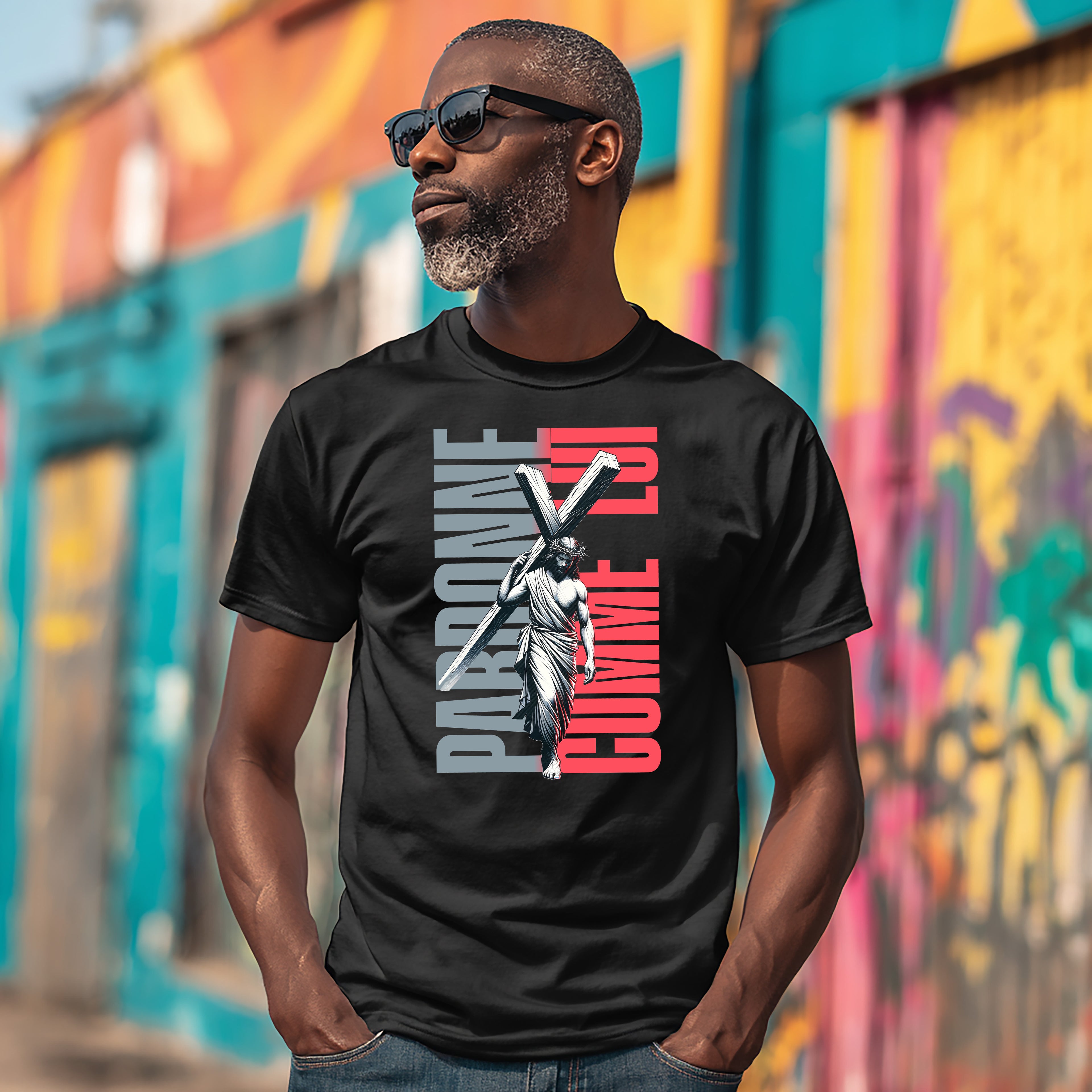 T-shirt Pardonne Comme Lui — t-shirt noir avec silhouette du Christ et texte orange rose
